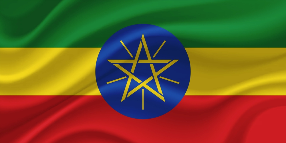 Flag of Ethiopia, showing green, yellow and red horizontal bands with a gold star on a blue disc