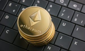 A stack of Ethereum coins on a keyboard