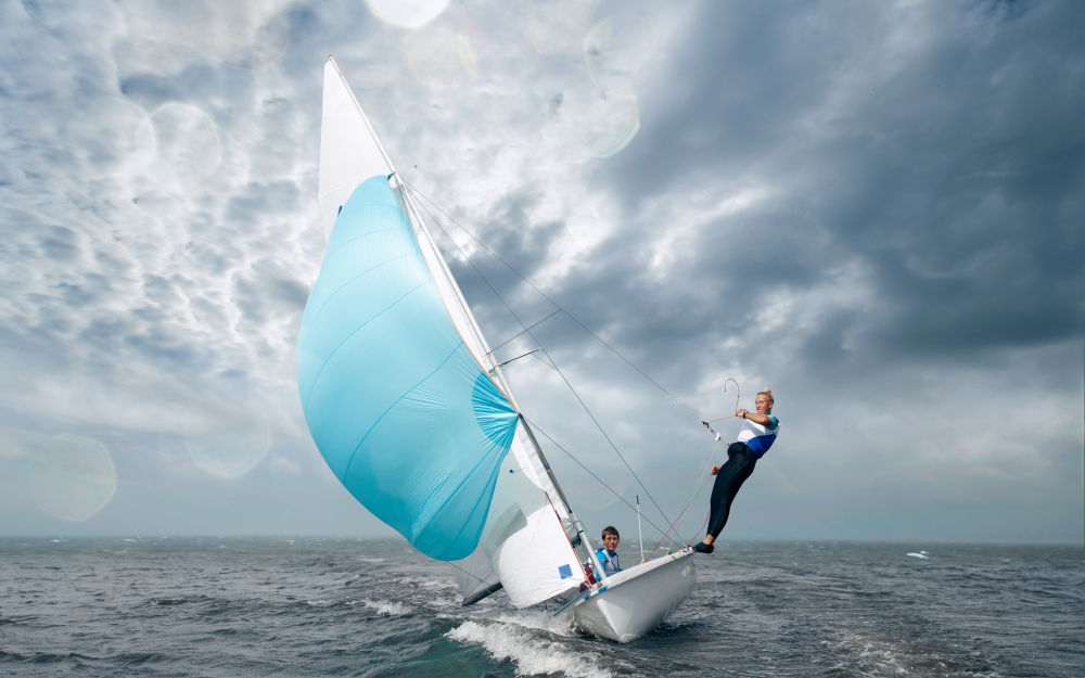 Sailing crew control boat in race Sailing crew control boat in race