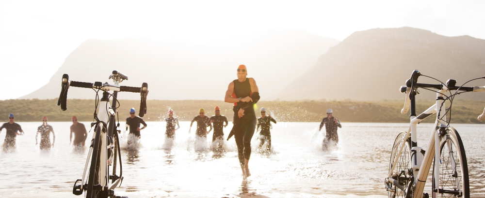 Triathletes emerge from swim stage.
