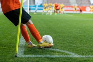 A soccer player takes a corner