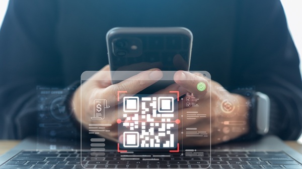 A man makes a payments via QR code